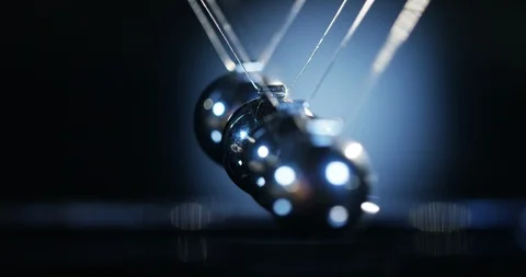 Pendulum made with steel balls mark the time in slow motion Stock Footage 115447773