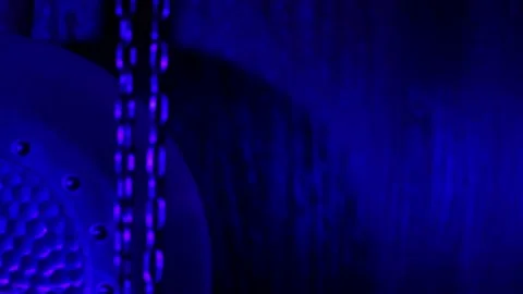 The pendulum of an old mechanical clock swinging in blue light Stockbeeldmateriaal 218318159