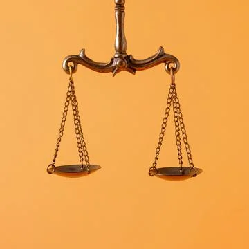 Pendulum scales over an orange background with copyspace Stock Photos