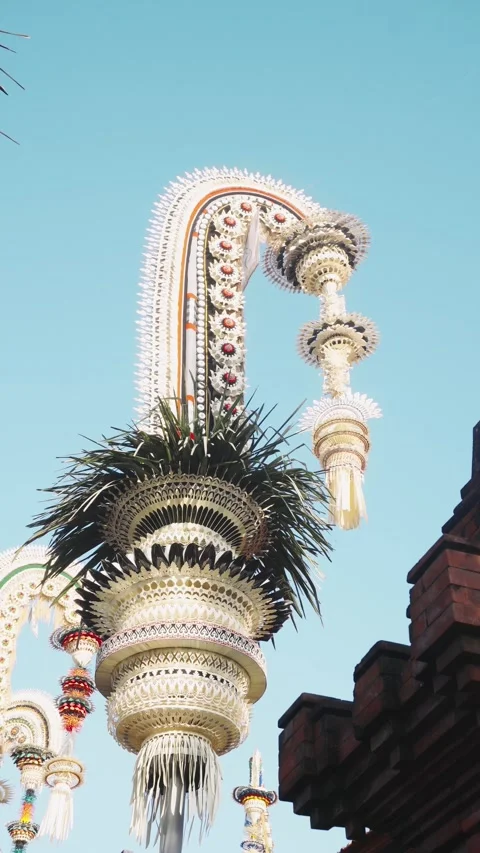 Penjor with Orange Stripe Arch and Red Brick Temple Context, Bali 4K Stock Footage 342384396