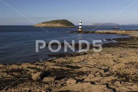 Penmon lighthouse and Puffin Island, Anglesey, North Wales coast Stock Photos