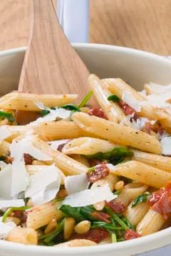 Penne with dried tomatoes, pine nuts and Parmesan Foto stock