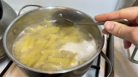 Penne Pasta Boiling in Pot of Hot Water on Stove Close-up Stock Footage 331811357