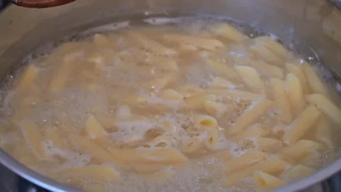 Penne Pasta Boiling in Water, Close-Up Cooking Process Stock Footage 336867035