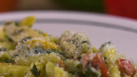Penne pasta is captured by a fork in this slow motion close up. Stock Footage 72539345