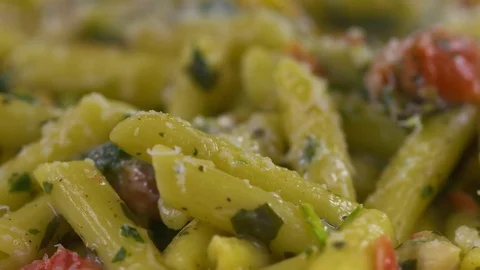 Penne pasta is captured by a fork in this slow motion close up. Stock Footage 72539604