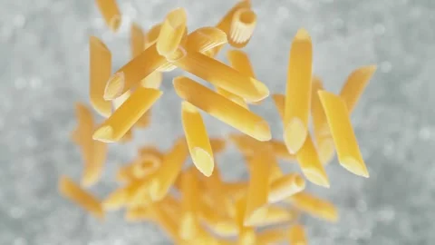 Penne Pasta Falling into Pot of Boiling Water Stock Footage 271397969