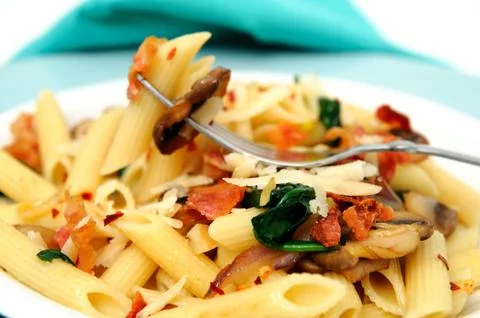 Penne pasta on a fork Stock Photos