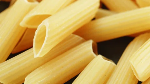 Penne pasta tubes macro close up presentation slowly rotating stock footage Stock Footage 344860975