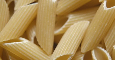 Penne pastas close up studio shot over rotating Stock Footage 324840184