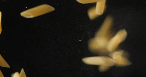 Penne pastas falling from below, slowmotion low angle 4K pro res Stock Footage 275897835