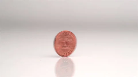 Penny Spinning On Table In Slow Motion Stock Footage 230380268