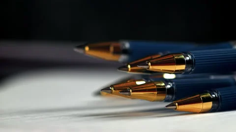 Pens fall on an open school notebook. Filmed on a high-speed camera at 1000 fps. Stock Footage 322742476