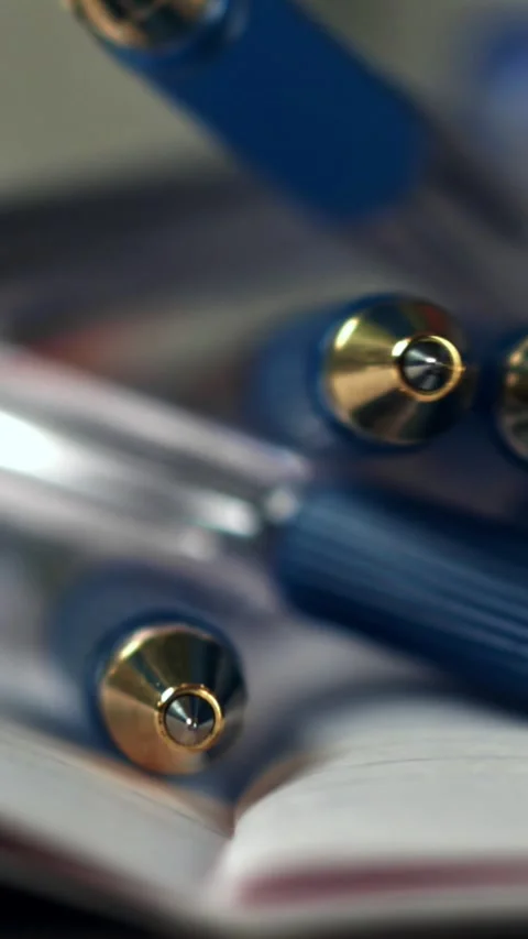 Pens fall on an open school notebook. Filmed on a high-speed camera at 1000 fps Stock Footage 335382179