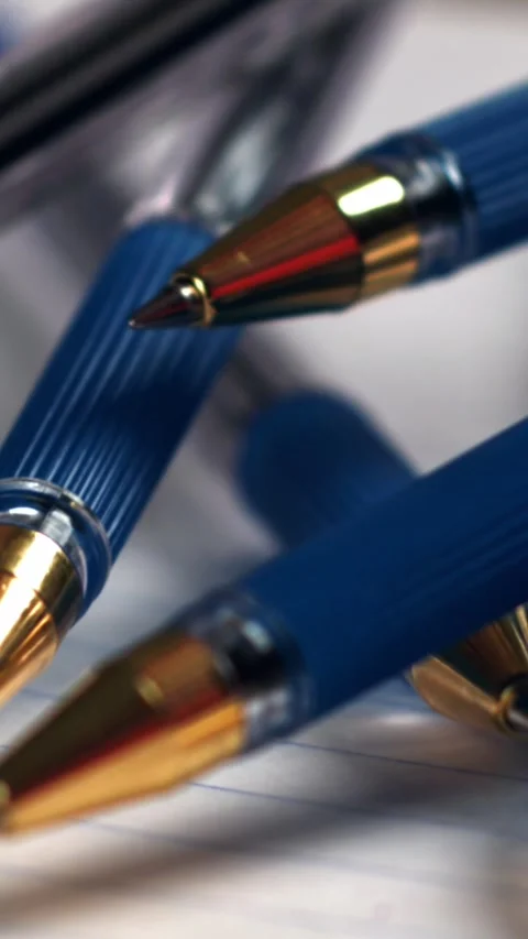 Pens fall on an open school notebook. Filmed on a high-speed camera at 1000 fps Stock Footage 335382957