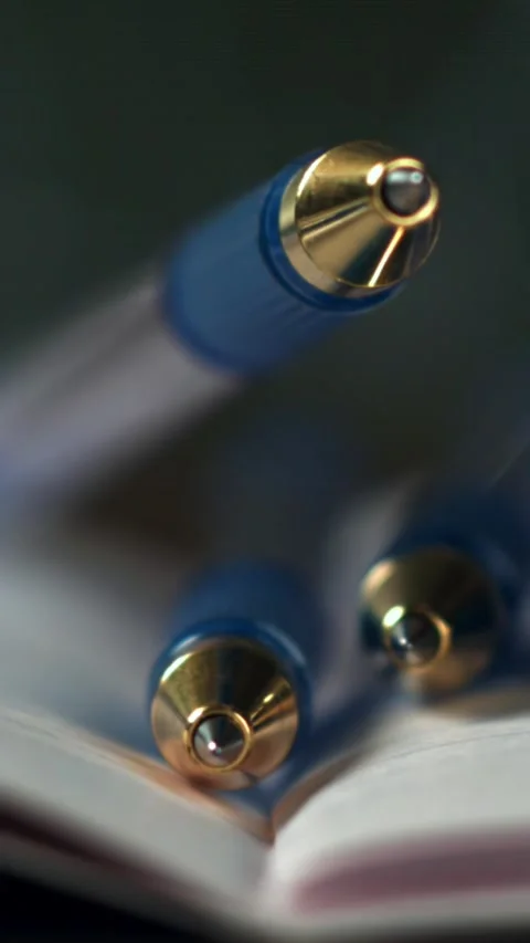 Pens fall on an open school notebook. Filmed on a high-speed camera at 1000 fps Stock Footage 335384170