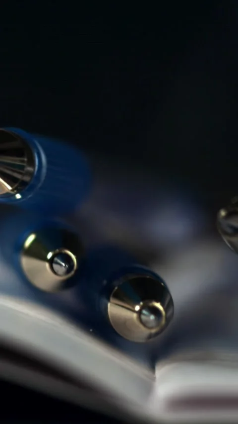 Pens fall on an open school notebook. Filmed on a high-speed camera at 1000 fps Stock Footage 335384572
