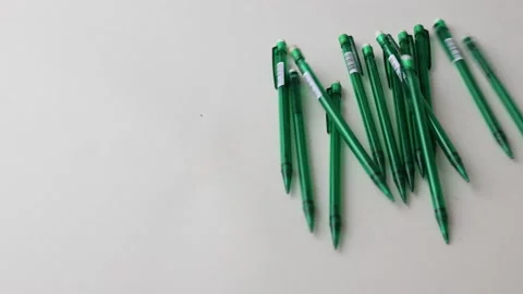 Pens falling on white background Stock Footage 145535994