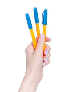 Pens in hand Stock Photos