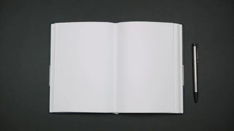 Pens moving like clockwise. Open notebook on desktop. Blank sheet Stock Footage 116770615