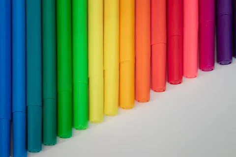 Pens stacked sequentially on a white surface. Great for backgrounds Stock Photos