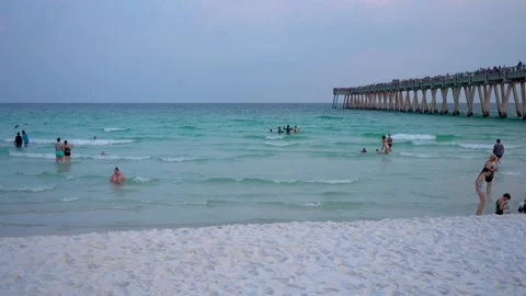 Pensacola’s white sandy beach, the soft golden light reflects off the calm Stock Footage 304681892