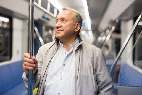 Pensioner 60 year old rides in an subway car Stock Photos
