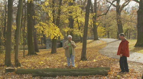 Pensioner balancing on treetrunk Stock Footage 279079