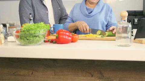 Pensioner couple preparing side dish together.  Stock Footage 102380975