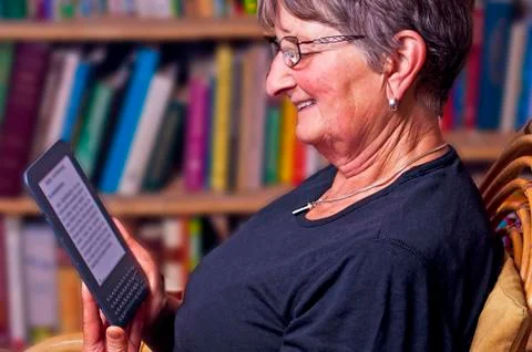 Pensioner with e-book reader Stock Photos