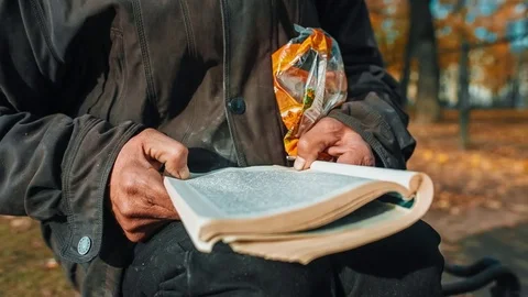 Pensioner Holding A Book Stockbeeldmateriaal 72998930
