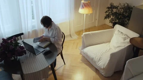 A pensioner looks through bills while sitting in front of a computer. Stock Footage 242141668