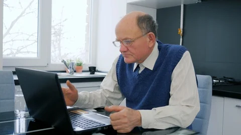 Pensioner Problems , elderly man works on computer in Internet Stock Footage 87217151