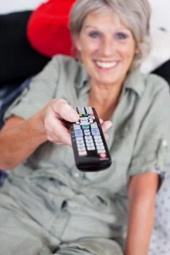 Pensioner with a remote control Stock Photos