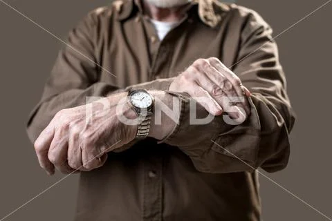 Pensioner showing his wristlet watch Stock Photos