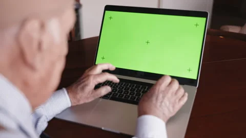 Pensioner working on trendy laptop computer with green screen chroma key Video stock 195545277