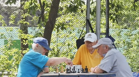 Pensioners playing chess with a clock in the Park Stock Footage 64893439