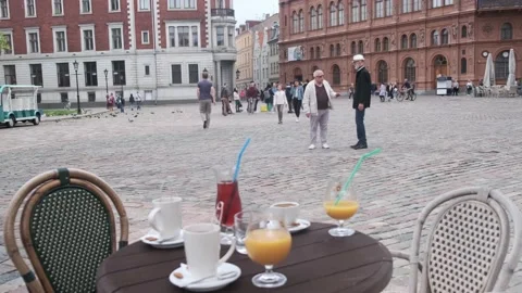 Pensioners walk to small table with different drinks in cafe Video stock 136418802