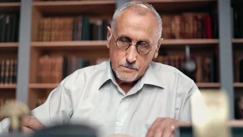 Pensive 70s elderly man scientist learning vintage literature university lecture Stock Footage 165035805