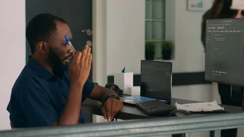 Pensive african american programer working on code development Stock Footage 227612517