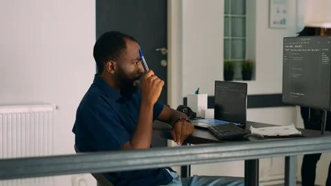 Pensive african american programer working on code development Foto stock
