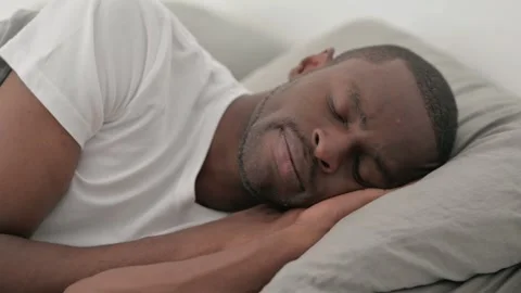 Pensive African Man Lying on Side in Bed Video stock 287903600