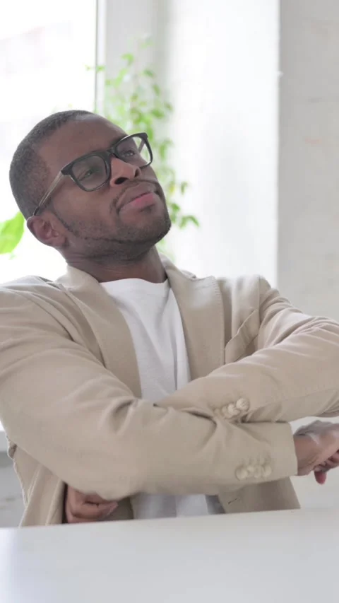 Pensive African Man Sitting in Office, Vertical Video Stock Footage 337350152