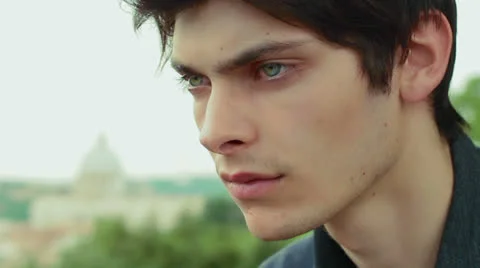 Pensive and depressed boy - have tears in his eyes - saint peter in background Stock Footage 26347795