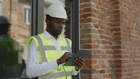 Pensive architect working on tablet near construction site Stock Footage 196887639