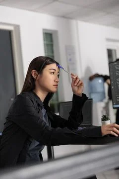 Pensive asian web developer working on html code development Foto stock