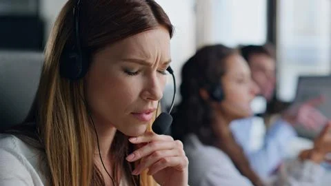 Pensive assistant looking solution closeup. Inspired woman in contact center Stock Photos