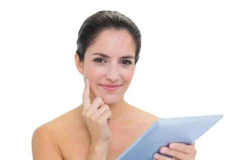 Pensive bare brunette using tablet 스톡 사진