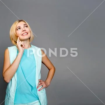 Pensive beautiful woman looks up Stock Photos