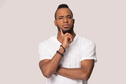 Pensive black male think of sale offer isolated in studio Stock Photos